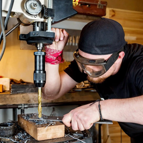 Person using Titanium Coated Drill Bit Set, 99-Piece HSS Kit With 135 Degree Tips And A Heavy Duty Storage Case on wood