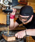Person using drill press with 230 Piece Titanium Coated Drill Bit Set With 135 Degree Tip Pro Grade HSS Drill Bits Kit.