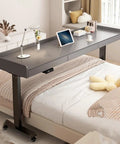 Stunning Electric Over Bed Table With Rolling Wheels And Adjustable Height, perfect for home office with spacious grey surface.