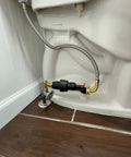 Automatic Toilet Leak Detector And Shutoff Valve Kit That Kicks Pesky Flush Leaks To The Curb And Saves Your Dough From Burst Hose Mayhem Using Hassle Free Installation, installed behind a toilet.