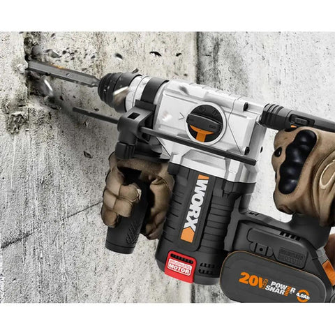 Built Different Heavy Duty Cordless Rotary Hammer Drill With Brushless Motor And Variable Speed Trigger drilling into concrete wall.