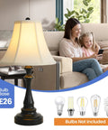 Three Piece Vintage Style Lamp Set with bronze finish, brown fabric shade table lamp on living room side table, bulbs shown
