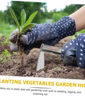 Hands using Stainless Steel Weeding Hoe Gardening Tool For Herb Garden Cultivator With Ergonomic Comfortable Handle in vegetable bed