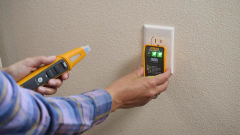 Person using 4 In 1 Breaker Finder, NCV Detector, Socket Tester And LED Flashlight on a wall outlet for circuit and voltage testing.