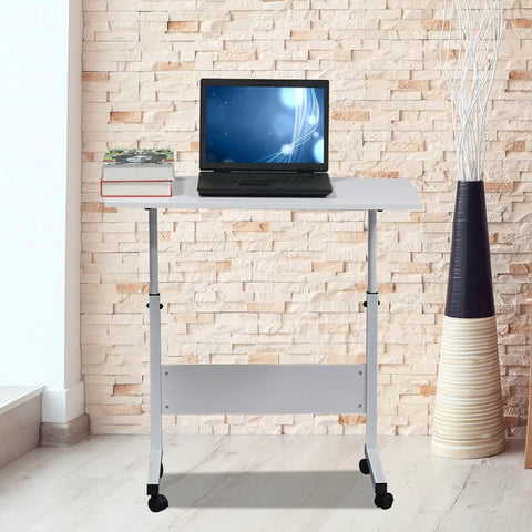 Kick Back And Crush Your Daily Grind With This Adjustable Standing Computer Desk Featuring Smooth Locking Wheels And A Foldable Rolling Laptop Table Built For Cozy Living Room Setups with laptop, books on white top.