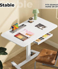 Flex Your Workspace Routine With This Slick Rollaway Standing Desk Featuring A Roomy Desktop Pull Out Storage Bin Built In Mug Holder Heavy Duty Side Hooks And Easy Glide Wheels, white ergonomic desk with storage and mobile design.