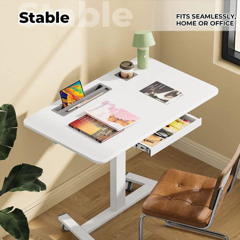Flex Your Workspace Routine With This Slick Rollaway Standing Desk Featuring A Roomy Desktop Pull Out Storage Bin Built In Mug Holder Heavy Duty Side Hooks And Easy Glide Wheels, white ergonomic desk with storage and mobile design.
