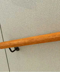 Solid Wooden Stair Handrail Built Tough For Indoor Outdoor Use With Smooth Non Slip Grip attached to a wall.