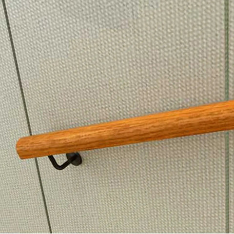 Solid Wooden Stair Handrail Built Tough For Indoor Outdoor Use With Smooth Non Slip Grip attached to a wall.