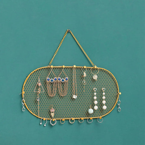 Wall Mounted Jewelry Organizer With Grid Design For Earrings Necklaces Bracelets And Watches In A Dope Sleek Iron Gold Finish Display Rack 35x18cm Durable Earring Holder And Necklace Hanger For Home Decor with jewelry displayed on a green wall