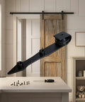 Heavy Duty Barn Door Hanger With Pointed Strap Rollers Rock Solid Metal Sliding Hardware on workspace table with tools.
