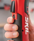 Close-up of hand gripping SKIL cordless tool, showcasing the Build Ready 12V Brushless Auto Hammer Kit Delivers Hella Compact Form Factor With Smooth Cordless Operation Includes Rapid USB C Battery Pack For Serious DIY Builds.