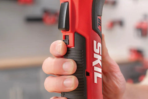 Close-up of hand gripping SKIL cordless tool, showcasing the Build Ready 12V Brushless Auto Hammer Kit Delivers Hella Compact Form Factor With Smooth Cordless Operation Includes Rapid USB C Battery Pack For Serious DIY Builds.
