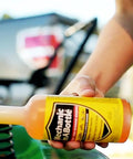 Gas And Diesel Fuel System Cleaner And Stabilizer 24 Oz 2 Pack pouring into fuel tank for smoother engine performance