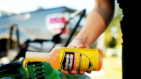 Gas And Diesel Fuel System Cleaner And Stabilizer 24 Oz 2 Pack pouring into fuel tank for smoother engine performance