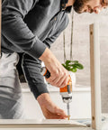 Person using drill with Deck Screws No 8 One And A Half Inch T25 Torx Drive Flat Head Wood Screws Tan for DIY project
