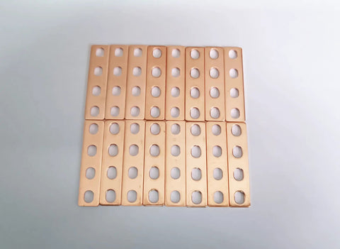 Top Shelf 16 Piece Purple Copper Battery Bus Bar Connection Plates for 5.5 6.2 and 6.9 Ah Lithium Cells laid out showing four hole layout.