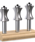 Premium Three Piece Convex Edge Oval Router Bit Set With One Half Inch Shank And Shallow Bullnose Profile displayed on wooden base.