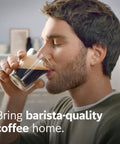 Man enjoying a cup of coffee showcasing Fully Automatic Espresso Machine With Ceramic Burr Grinder Offering Straight Up Perfect Bean To Cup Coffee Through No Sweat One Touch Brewing And Creamy Milk Frother.
