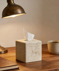 Heavy Resin Tissue Box Cover With Travertine Texture For Home Decor on a wooden table next to a lamp and coffee mug