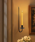 Upgrade Your Digs With These Dope Black Metal Wall Candle Sconce Holder Set Of Two Featuring Removable Taper And Pillar Disks For A Chill Cozy Ambiance, black metal wall sconce with a yellow taper candle.