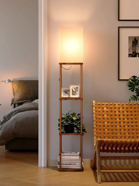 Dope 4 Tier Shelf Floor Lamp With 3CCT LED Bulb in a living room, displaying photos and a plant on brown shelves.