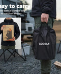 Person holding storage bag and box for Portable Wood Burning Camp Stove With High Efficiency Rocket Style Flame For Camping Backyard Cookouts and Outdoor Events Includes Storage Bag And Rugged Weatherproof Construction For Easy Transport.