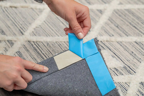 Applying Blue Double Sided Duct Tape Roll 1.4 Inch By 12 Yards With Aggressive Natural Rubber Adhesive to carpet