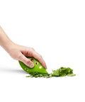 Zero Stress Leaf Stripper For Fresh Kale And Collard Greens With Super Sharp Curved Cutting Edge Quick Herb Chopper Kitchen Gadget in hand chopping herbs.
