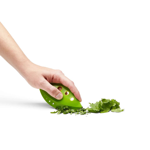 Zero Stress Leaf Stripper For Fresh Kale And Collard Greens With Super Sharp Curved Cutting Edge Quick Herb Chopper Kitchen Gadget in hand chopping herbs.