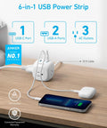 Power Strip With 20W USB C PD 3 Outlets And USB A Ports 10 Ft Extension Cord showing plugged phones and devices on desk