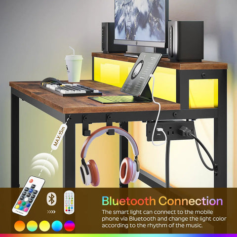 Small Computer Desk With Charging Station And LED Lights, Gaming Desk With Monitor Stand, 2-Tier Home Office Desk in use with accessories