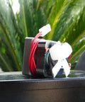 Upgraded Heavy Duty Auger Motor For Pellet Grills Plug And Play Quick Install With Shear Pin And Nut Includes One Year Warranty Silver Finish No Sweat Operation Totally Reliable motor with red wires and white fan on a dark surface.