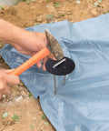 Installing 100 Pack 6 Inch Landscape Staples With Gasket Washers for securing landscaping fabric in garden