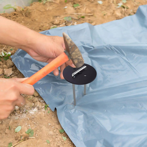 Installing 100 Pack 6 Inch Landscape Staples With Gasket Washers for securing landscaping fabric in garden