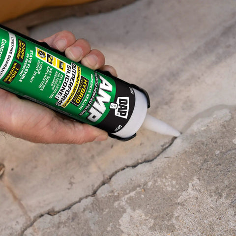 Person applying Gray Concrete Sealant For Driveways, Steps, And Sidewalks, All Weather Tough As Nails Hybrid Polymer Sealant, 9 Oz