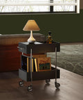 Ride Smooth Black Two Tier Mobile Bar Cart With Secure Roller Wheels Home Serving Stand Kitchen Drink Station Glass Top Steel Rack Casual Flex Storage in living room with lamp and drinks.