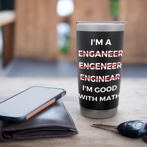 Funny Engineer Tumbler With Sarcastic Math Jokes And Misspelling Humor, Stainless Steel Insulated Travel Cup on a table with wallet and phone
