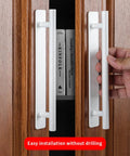 Two Pack Stick On Cabinet Handles White Self Adhesive Drawer Pulls Closet Doors For Kitchen Sliding Glass And Shower Doors No Drilling Easy Install Eight And A Half Inch Long One Inch Wide shown being installed on wooden cabinet.