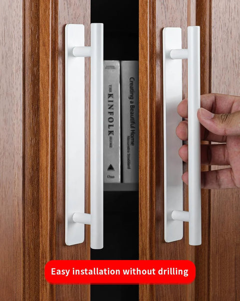 Two Pack Stick On Cabinet Handles White Self Adhesive Drawer Pulls Closet Doors For Kitchen Sliding Glass And Shower Doors No Drilling Easy Install Eight And A Half Inch Long One Inch Wide shown being installed on wooden cabinet.