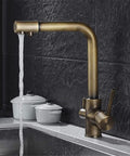 360-Degree Rotating Antique Bronze Kitchen Faucet Water Purifier 3-Way Dual Filter Tap with flowing water in kitchen setting.