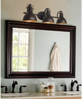 Beacon 27 Inch Three Light Industrial Vanity Light With Brass Interior Shades Modern Farmhouse Wall Sconce in bathroom setting
