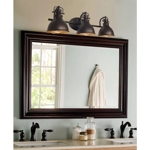 Beacon 27 Inch Three Light Industrial Vanity Light With Brass Interior Shades Modern Farmhouse Wall Sconce in bathroom setting