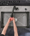 Overhead view of 20 Inch Black Stainless Steel Kitchen Sink Single Bowl Nano Self Cleaning Undercounter Workstation With Accessories Pro Grade Quiet Built In Design Stain Resistant And Easy To Clean, showing quick drainage feature with hands washing an apple.