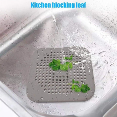 3 Pack 5.5 Inch Silicone Drain Covers With Strong Suction Bases Flat Square Hair Catchers For Showers And Kitchen Sinks Reusable Gray Strainers in kitchen sink with water and leaves