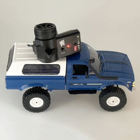 Blue All Terrain 1/16 Scale RC Rock Crawler 4x4 Ready To Run Pickup Truck With remote control on top, dual batteries visible