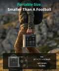 Person carrying Portable Power Station C600 600W Solar Generator With 640Wh LiFePO4 Battery outdoors, smaller than a football.