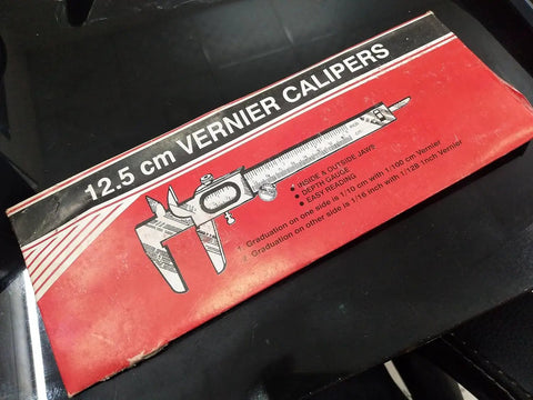 VMRG Non-Digital Vernier Caliper box displaying 12.5 cm size and features for measuring with metric and imperial units.