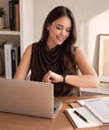 Killer Genuine Leather Watch Strap Compatible With Apple Watch For Women on a woman's wrist while she works on a laptop.