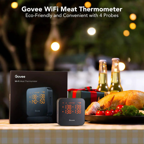 WiFi Meat Thermometer With 4 Probes displayed next to its packaging on a table with a roasted chicken and decorations in the background.